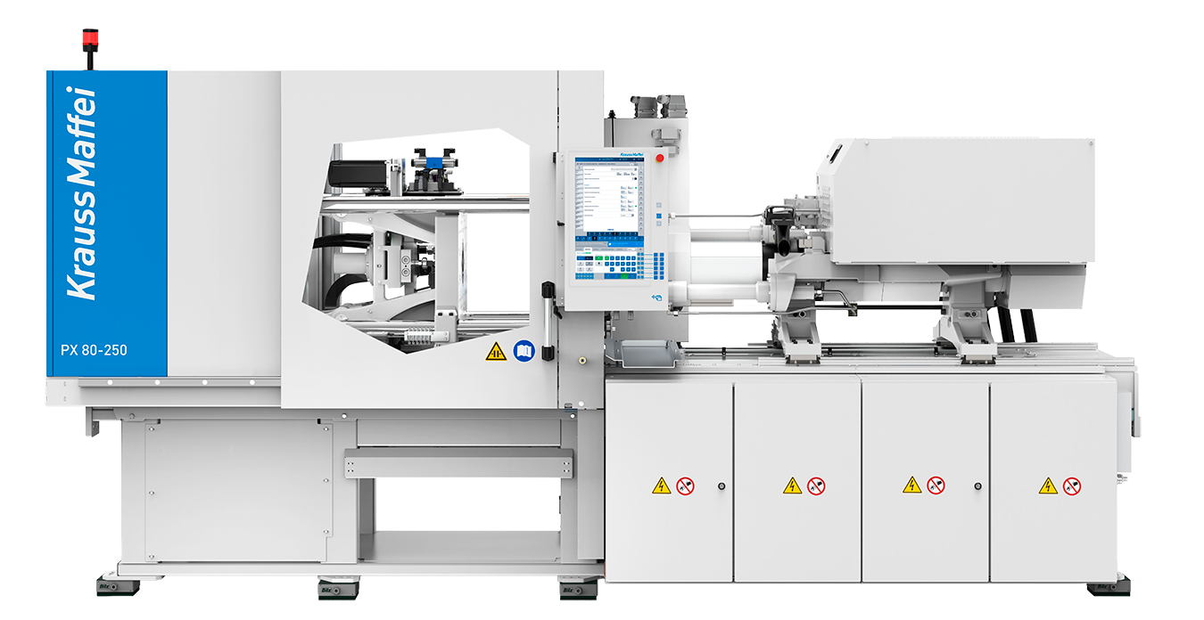 A white Krauss Maffei injection molding machine for spritzgießen with blue branding is shown. The machine features a control panel with a display screen, a viewing window, visible mechanical components, and warning labels on panel doors. The background is plain white.